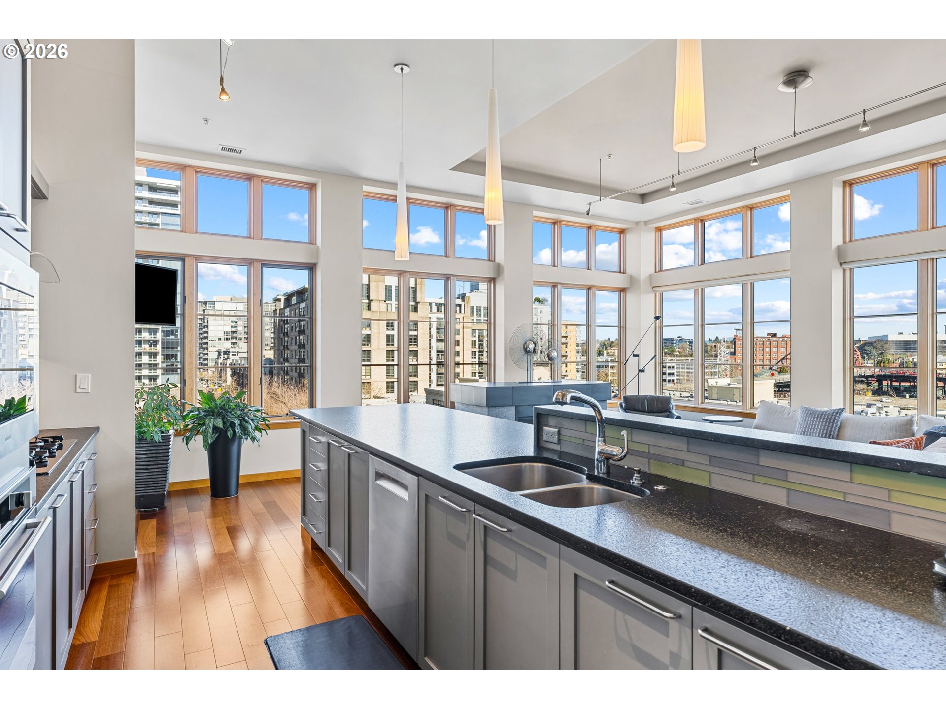 1030 Northwest Johnson Street, Unit 611 Portland, OR 97209 - Photo 10 of 34 a open kitchen with stainless steel appliances kitchen island granite countertop a sink and cabinets