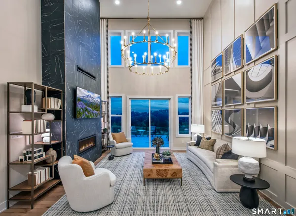 a living room with fireplace furniture and a large window