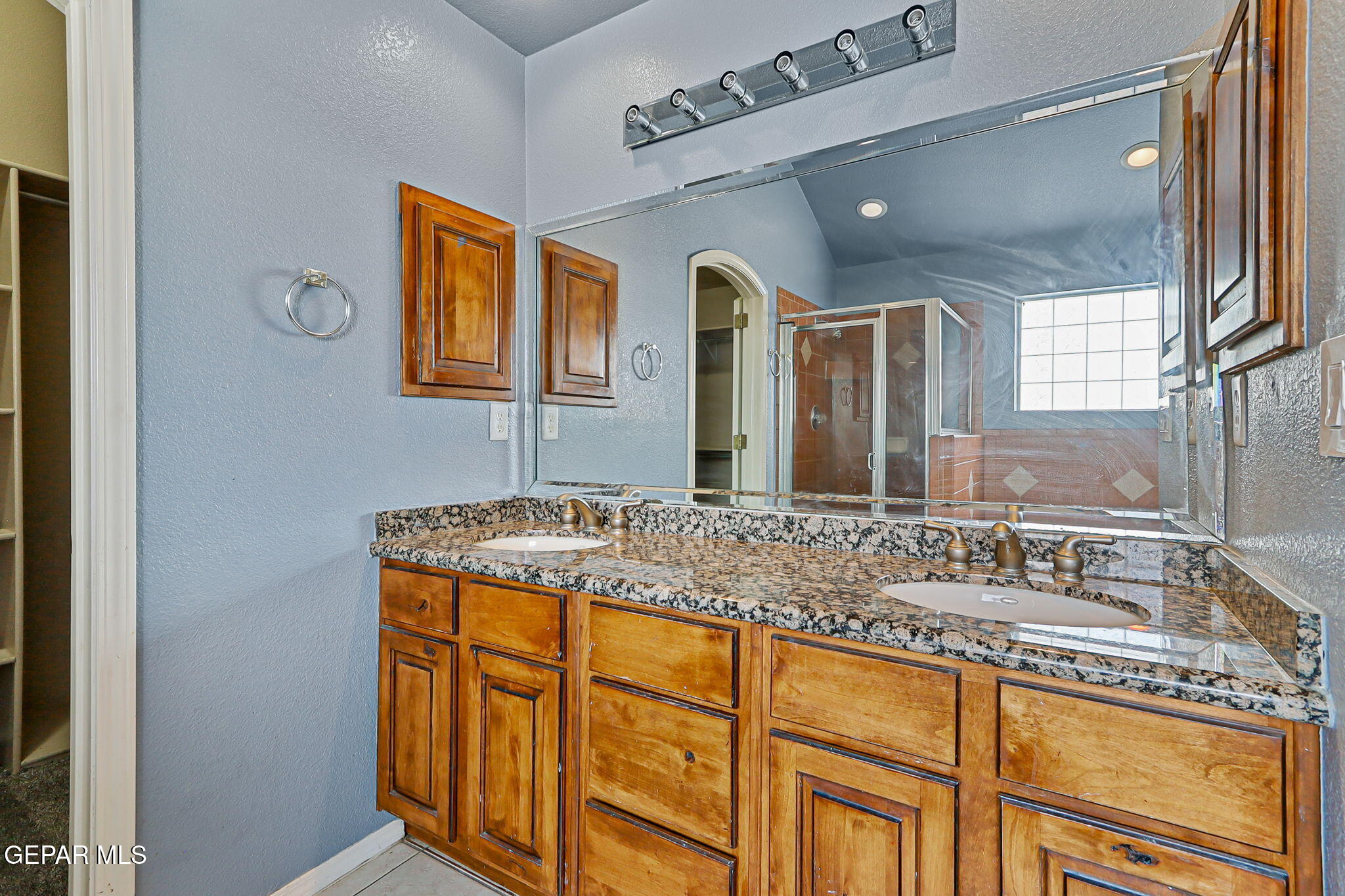 3644 Tierra Inca Drive El Paso, TX 79938 - Photo 31 of 53 a bathroom with a granite countertop sink and a mirror