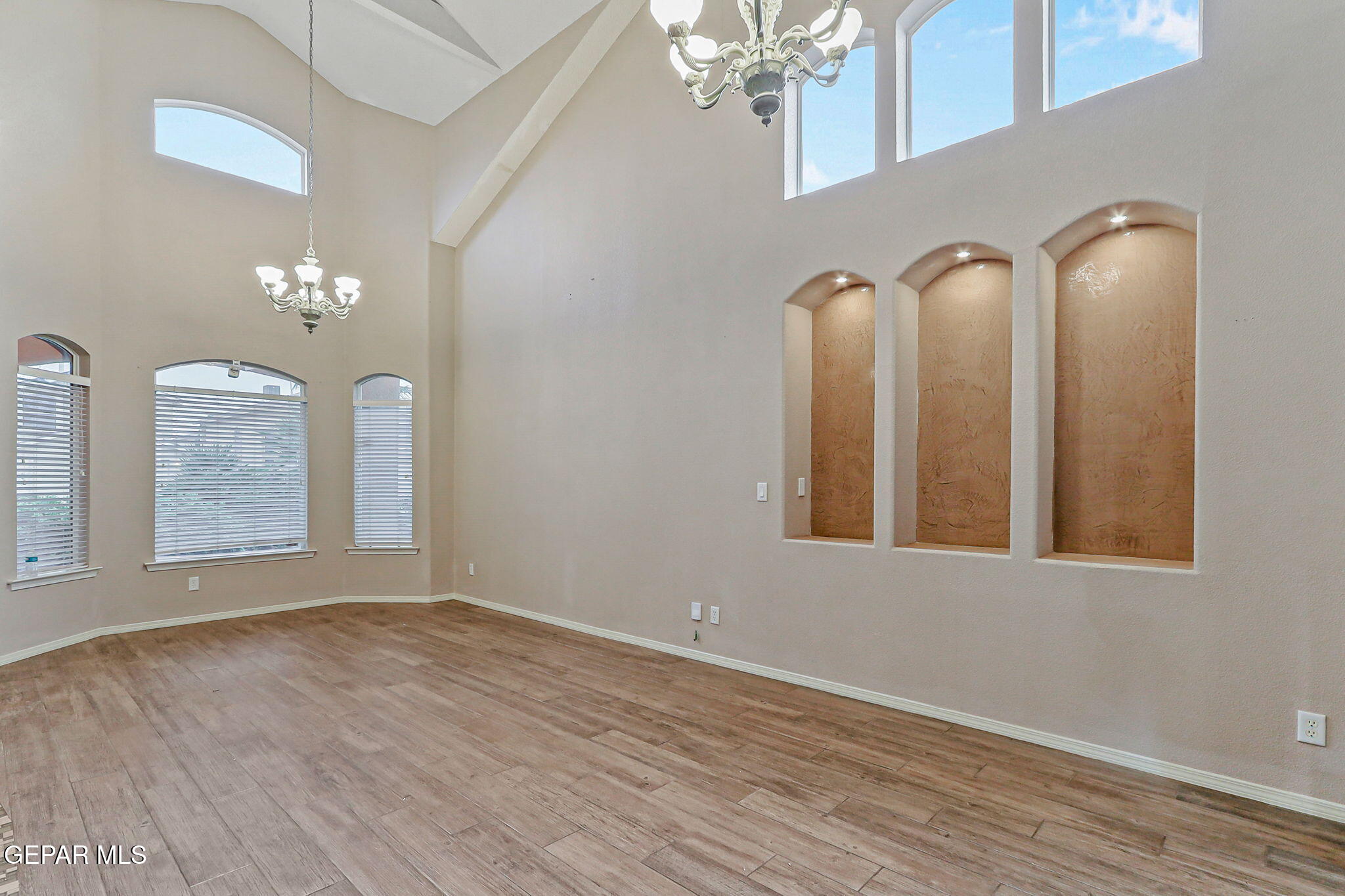 3644 Tierra Inca Drive El Paso, TX 79938 - Photo 6 of 53 a view of a hallway with entryway wooden floor and chandelier