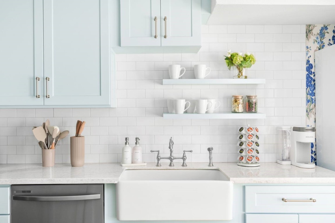3236 Binz Street Houston, TX 77004 - Photo 12 of 50 a kitchen with white cabinets and a sink