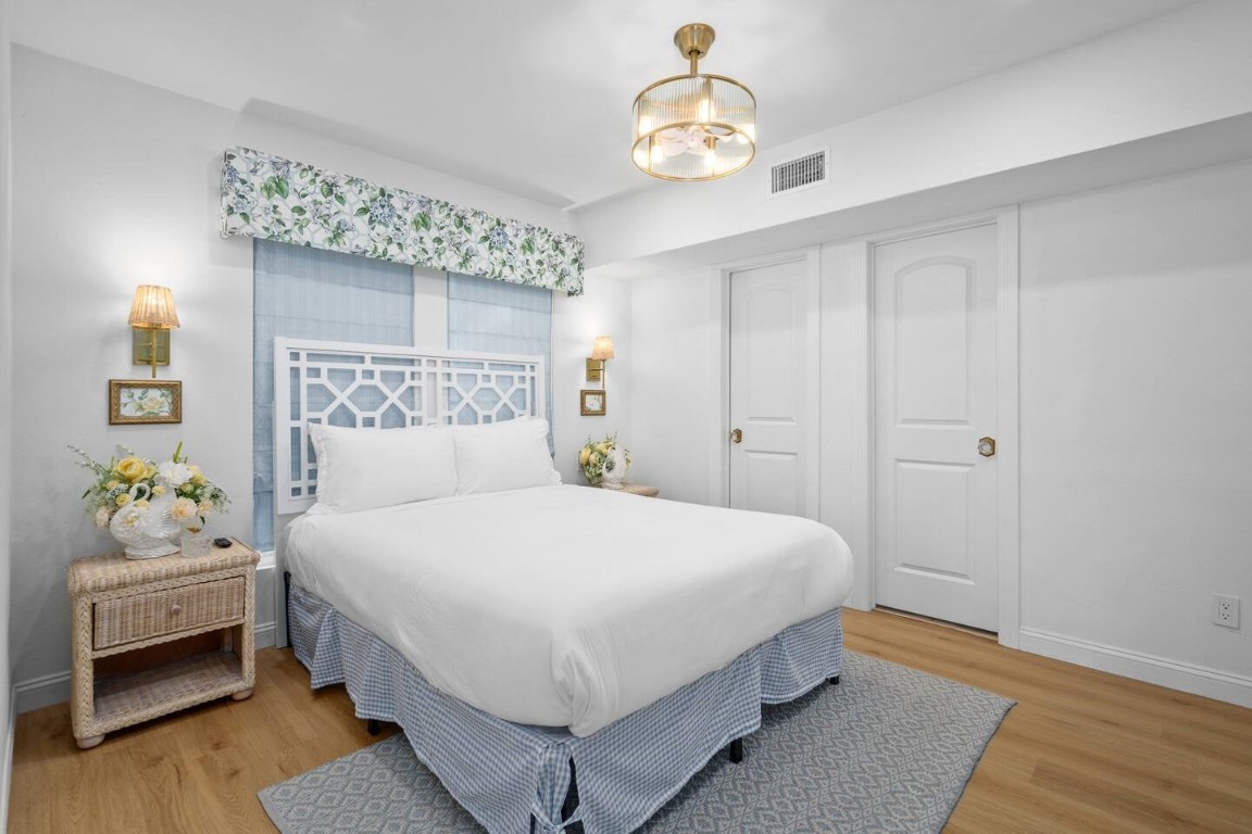 3236 Binz Street Houston, TX 77004 - Photo 14 of 50 a bedroom with a bed and a chandelier