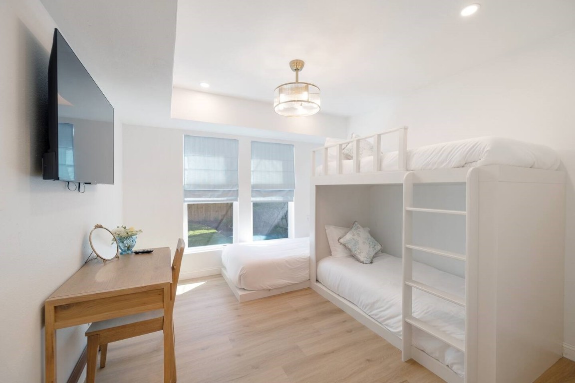 3236 Binz Street Houston, TX 77004 - Photo 20 of 50 a bedroom with a large bed and flat screen tv