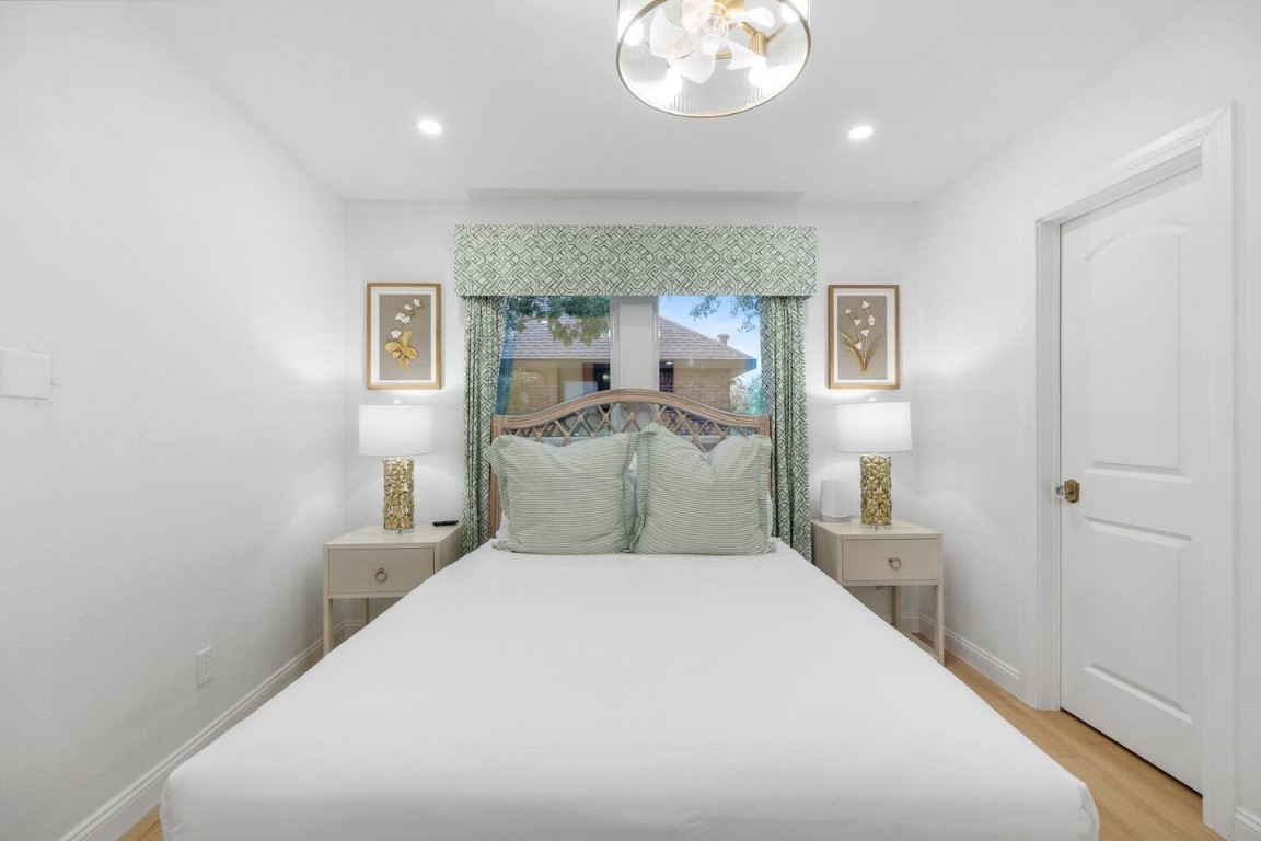3236 Binz Street Houston, TX 77004 - Photo 37 of 50 a bedroom with a bed and a chandelier