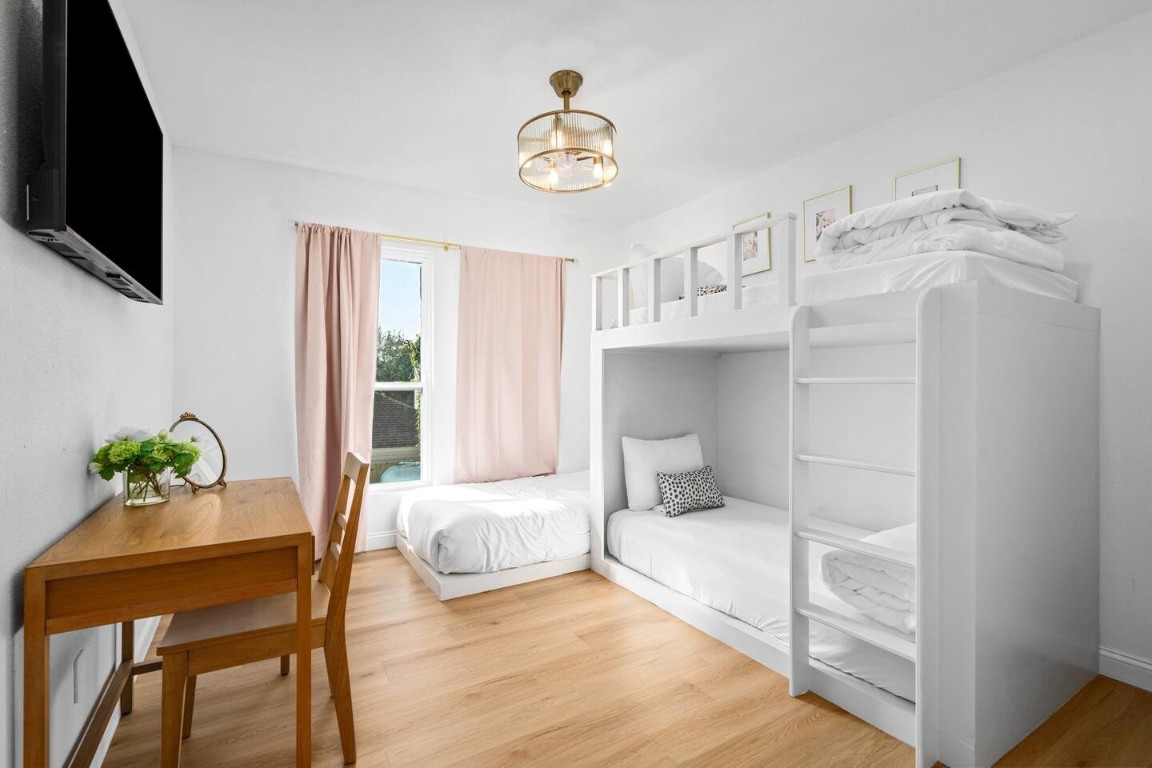 3236 Binz Street Houston, TX 77004 - Photo 41 of 50 a bedroom with a bed and a chandelier