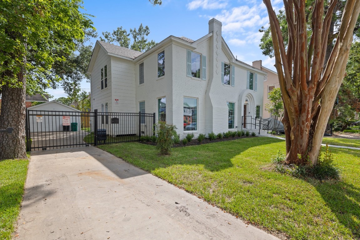 3236 Binz Street Houston, TX 77004 - Photo 49 of 50 a view of a white house next to a yard with big trees and plants