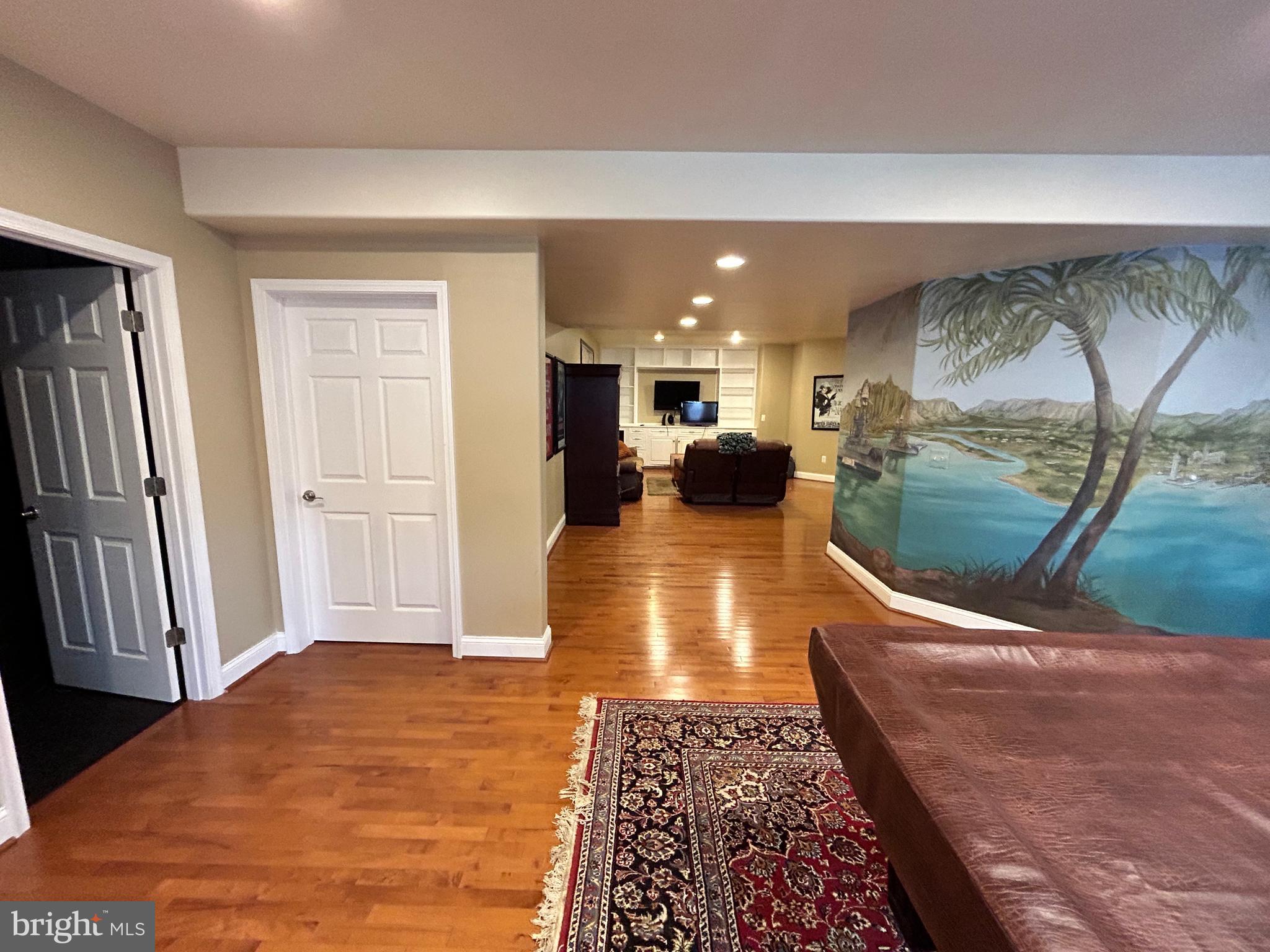 690 Good Shepherd Way Owings, MD 20736 - Photo 15 of 27 a living room with a couch and a table with wooden floor