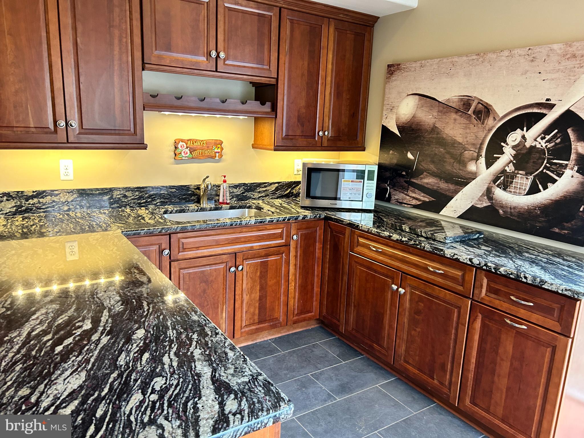 690 Good Shepherd Way Owings, MD 20736 - Photo 6 of 27 a kitchen with stainless steel appliances granite countertop a stove a sink and a microwave