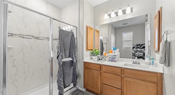 a bathroom with a double vanity sink mirror and double