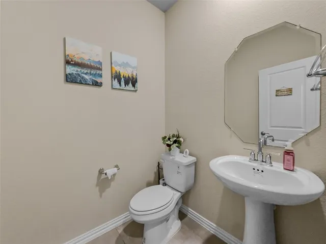 a bathroom with a sink toilet and mirror