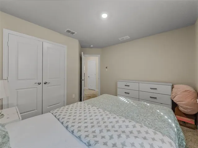 a bedroom with a bed and a closet