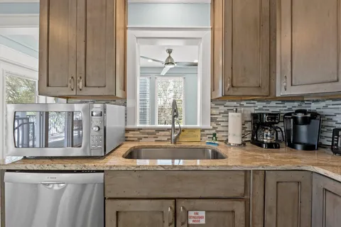 a bathroom with a granite countertop sink toilet and mirror