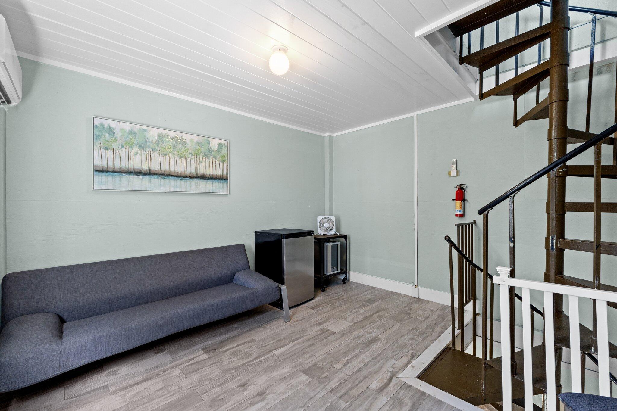 91 Cypress Hill Road Santa Rosa Beach, FL 32459 - Photo 50 of 66 a living room with wooden floor and stairs