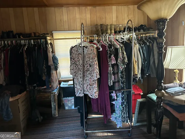 a view of walk in closet with clothes