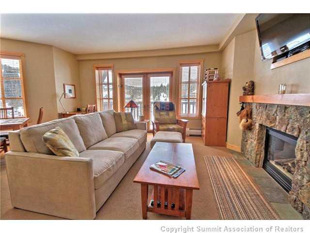 910 Copper Road, Unit 320 Copper Mountain, CO 80443 - Photo 21 of 24 a living room with furniture a flat screen tv and a fireplace