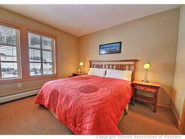 910 Copper Road, Unit 320 Copper Mountain, CO 80443 - Photo 5 of 24 a bedroom with a bed and a night stand