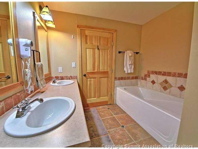 910 Copper Road, Unit 320 Copper Mountain, CO 80443 - Photo 6 of 24 a bathroom with a tub sink and mirror