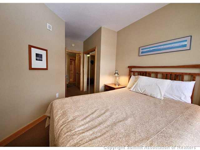 910 Copper Road, Unit 320 Copper Mountain, CO 80443 - Photo 8 of 24 a bedroom with a bed and a painting on the wall