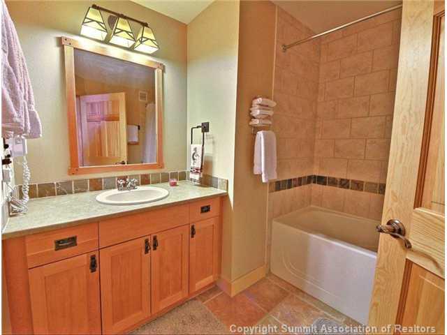 910 Copper Road, Unit 320 Copper Mountain, CO 80443 - Photo 9 of 24 a bathroom with a tub a sink and mirror