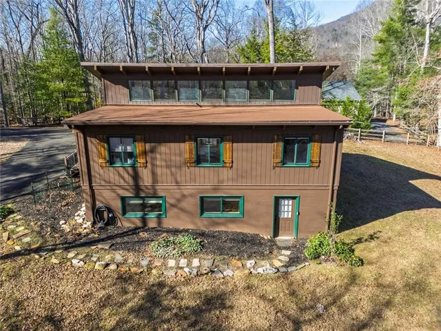 a backyard of a house with table and chairs