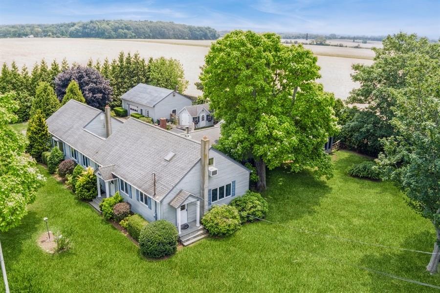 an aerial view of a house with a yard and lake view