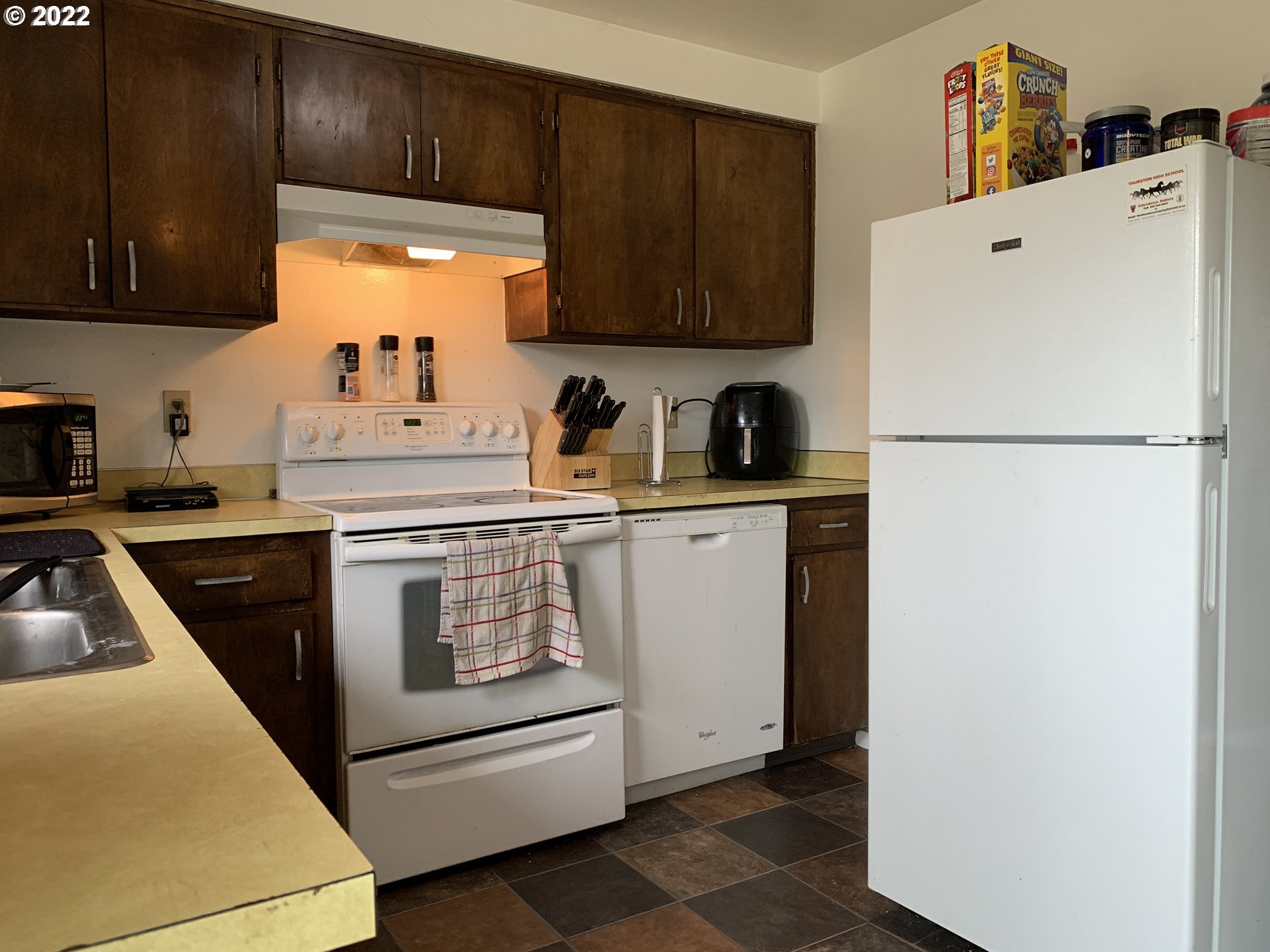 296 South 50th Place Springfield, OR 97478 - Photo 29 of 32 a white refrigerator freezer sitting in a kitchen