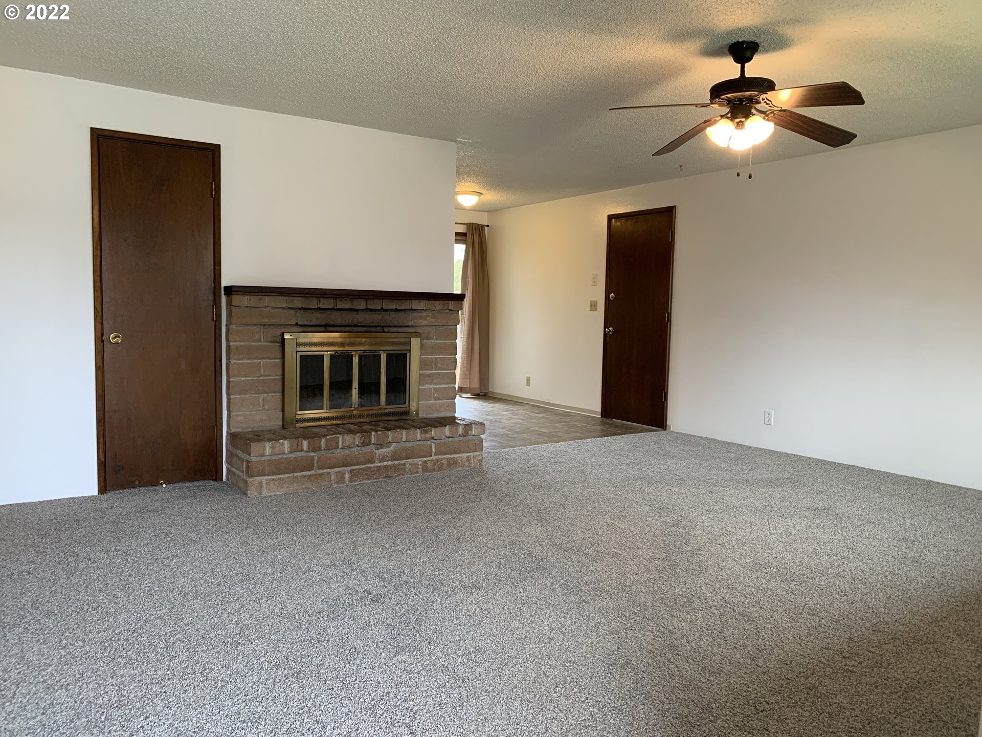 296 South 50th Place Springfield, OR 97478 - Photo 3 of 32 a living room with furniture and a fireplace