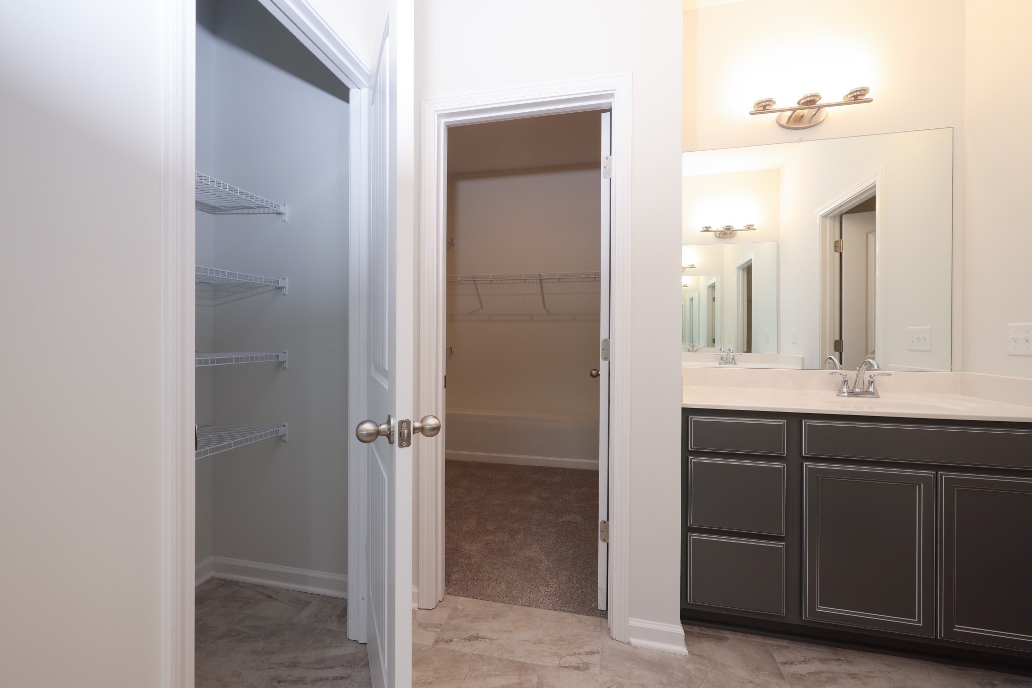 7649 Knobdate Road Smyrna, TN 37167 - Photo 12 of 23 a bathroom with a double vanity sink a mirror and a shower