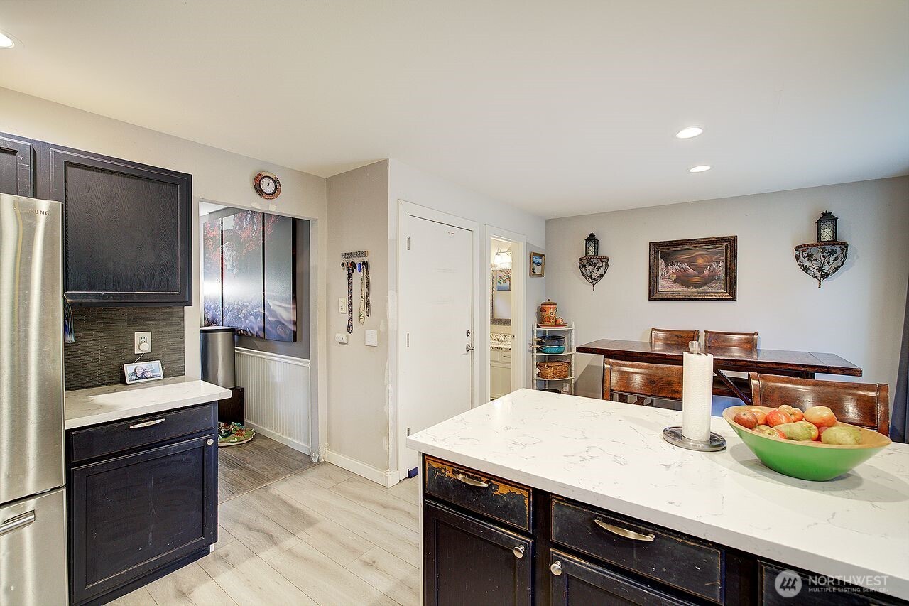 44212 Fir Road Gold Bar, WA 98251 - Photo 12 of 34 a kitchen with stainless steel appliances kitchen island granite countertop a refrigerator a sink and dishwasher