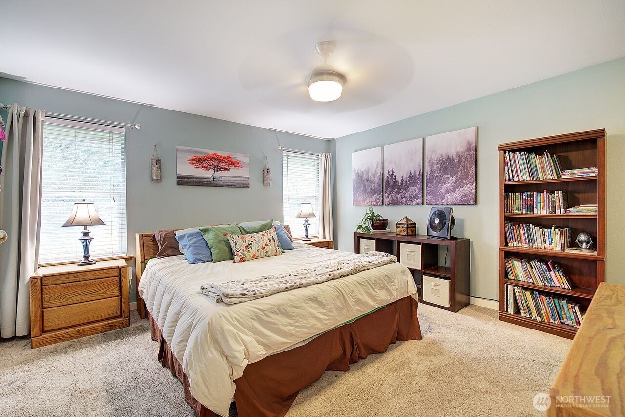 44212 Fir Road Gold Bar, WA 98251 - Photo 20 of 34 a bedroom with a bed a dresser and a large window