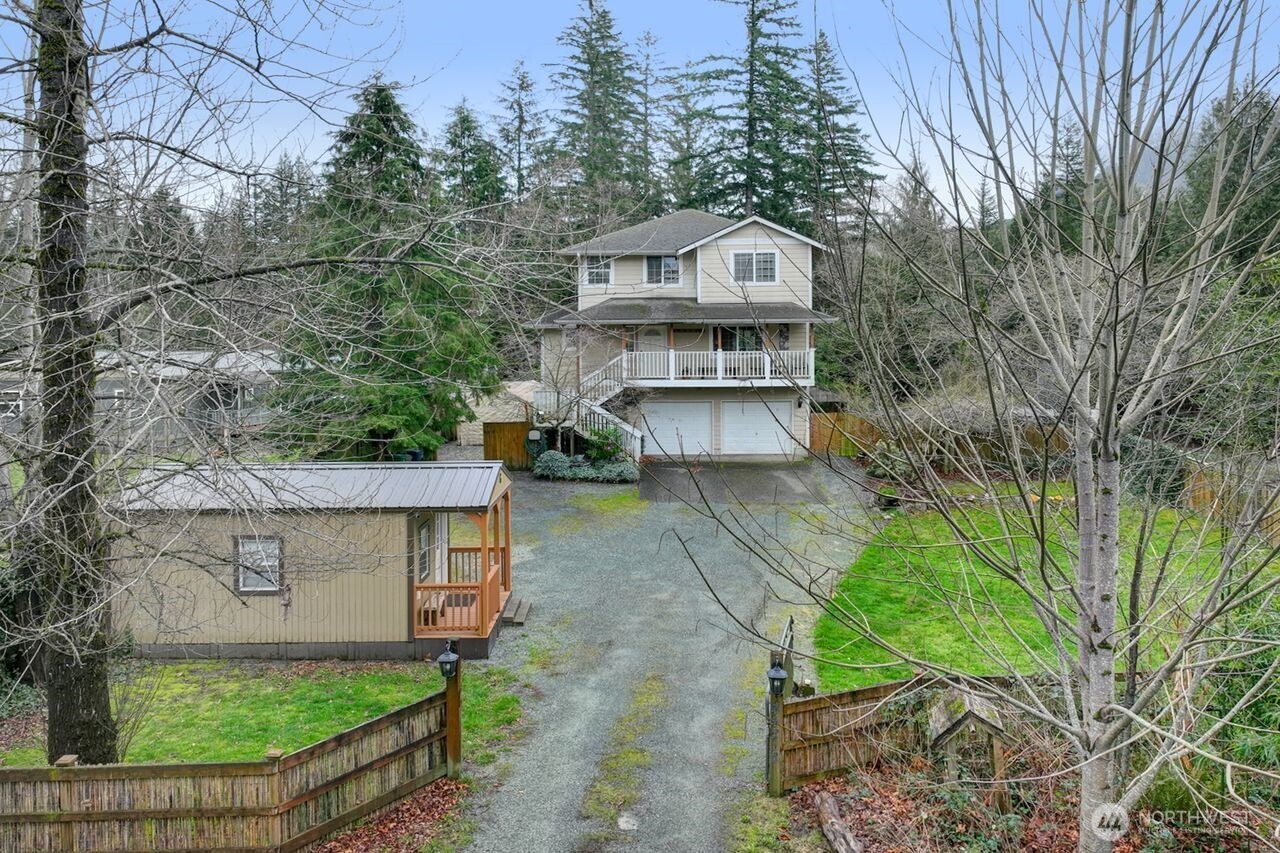 44212 Fir Road Gold Bar, WA 98251 - Photo 2 of 34 a view of a big house with a big yard and large trees