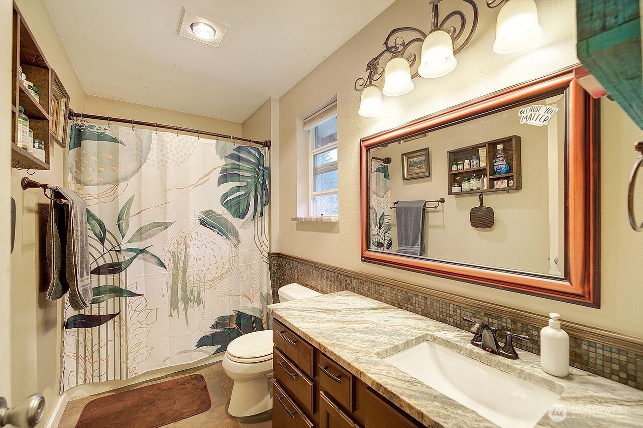 44212 Fir Road Gold Bar, WA 98251 - Photo 21 of 34 a bathroom with a granite countertop sink toilet and a mirror