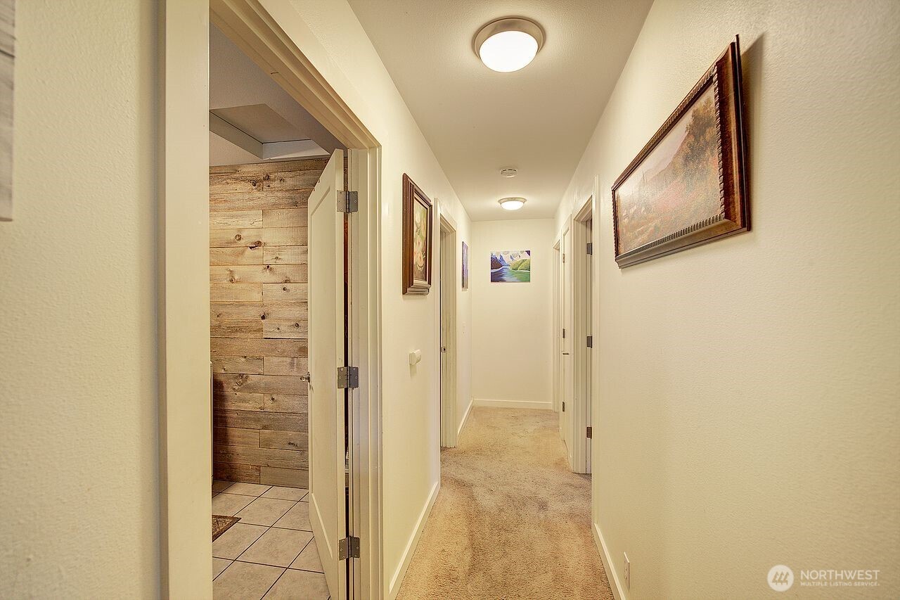 44212 Fir Road Gold Bar, WA 98251 - Photo 23 of 34 a view of a hallway with wooden shelves