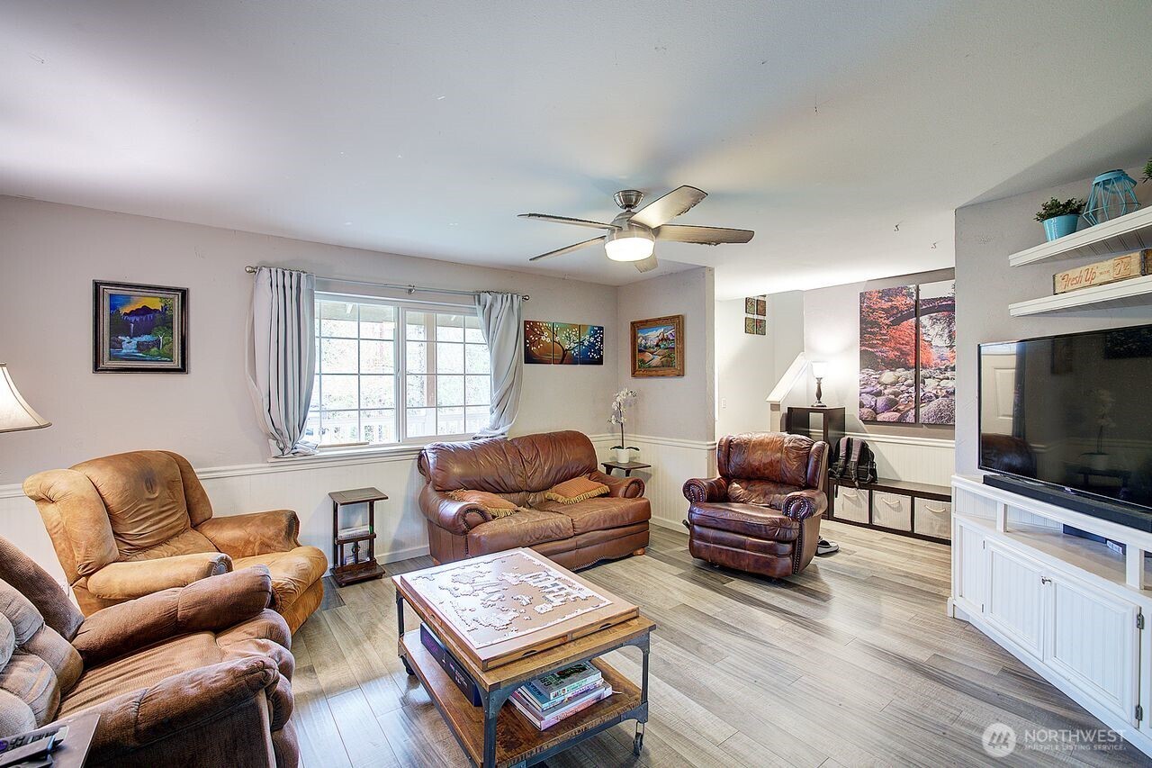 44212 Fir Road Gold Bar, WA 98251 - Photo 8 of 34 a living room with furniture a flat screen tv and a window
