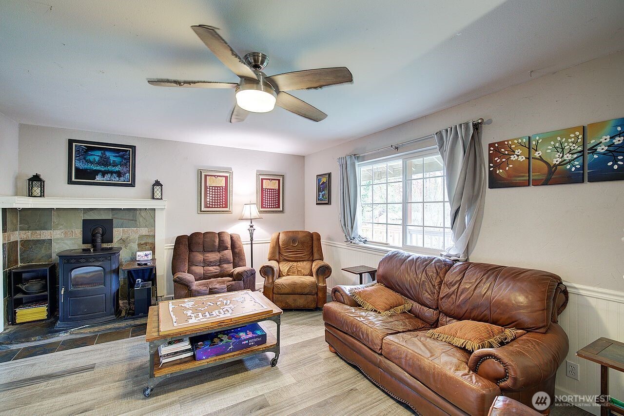 44212 Fir Road Gold Bar, WA 98251 - Photo 9 of 34 a living room with furniture a fireplace and a window