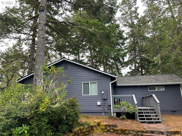 87179 Munsel Lake Road Florence, OR 97439 - Photo 3 of 27 a view of a barn house with a large window and wooden fence