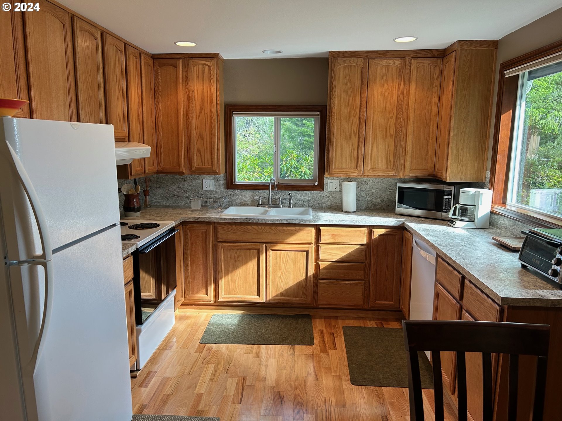 87179 Munsel Lake Road Florence, OR 97439 - Photo 10 of 27 a kitchen with a refrigerator a sink and a stove top oven