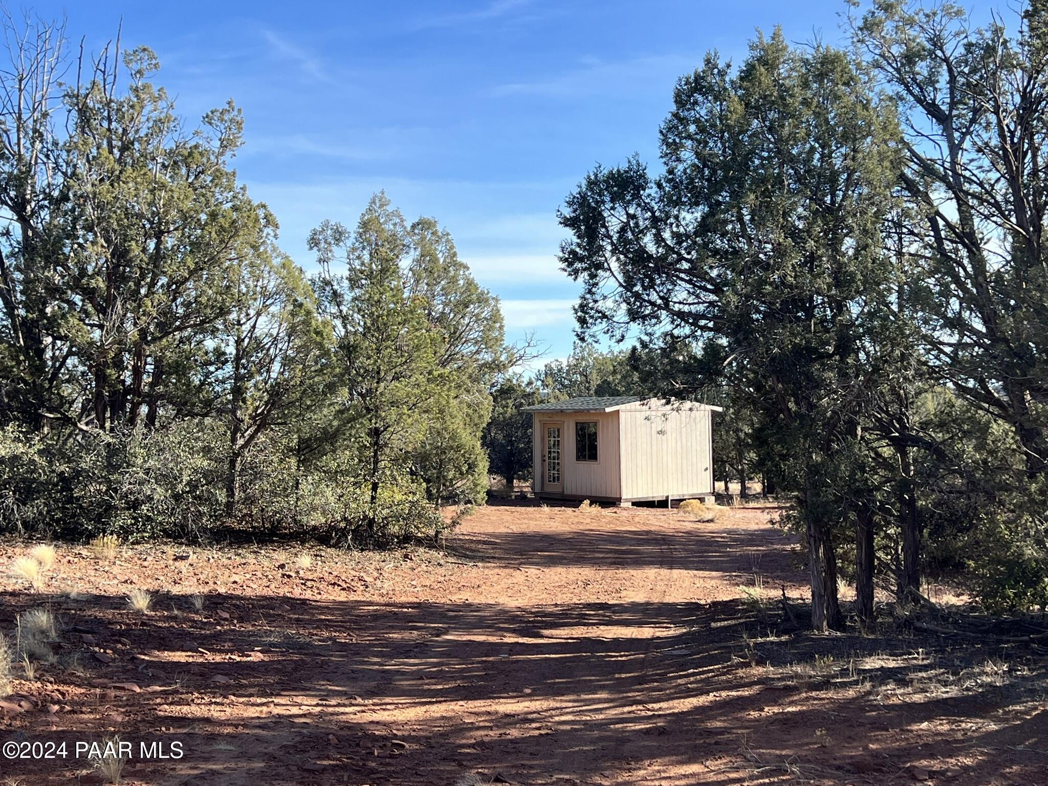 49 Southwest Norma Way Ash Fork, AZ 86320 - Photo 3 of 13 a white house that has a tree in front of it