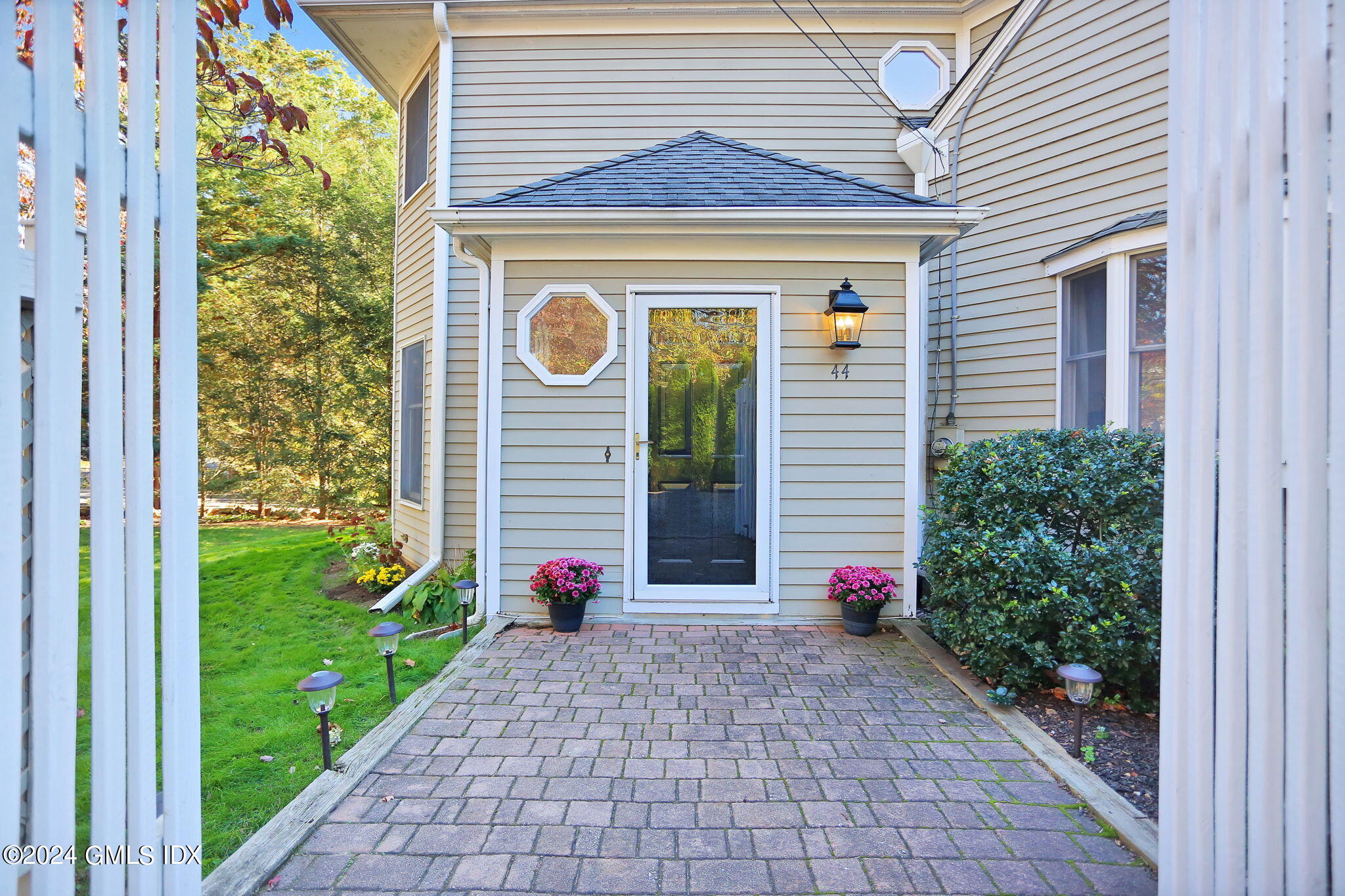 a view of a house with potted plants