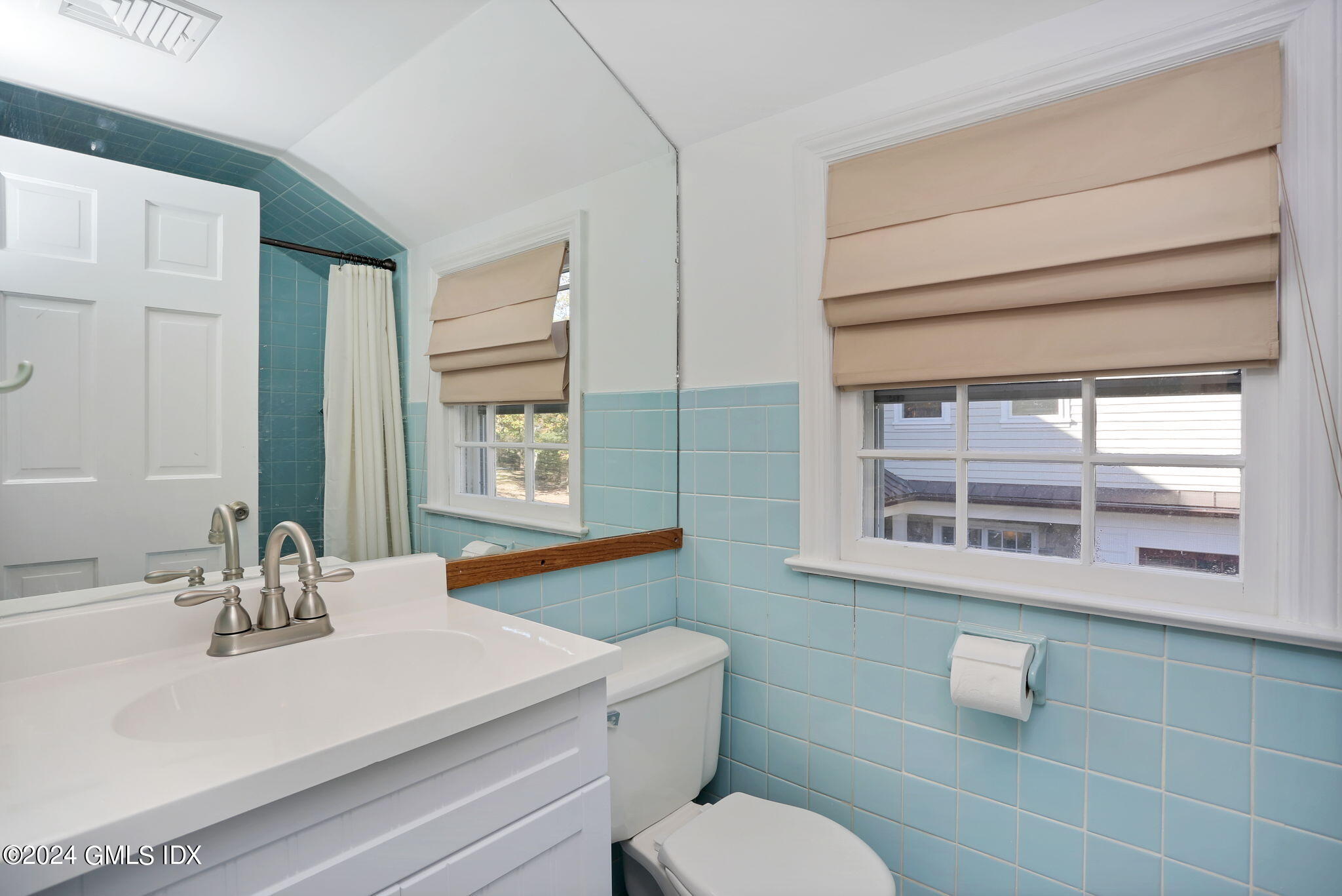 44 Hendrie Avenue Riverside, CT 06878 - Photo 20 of 40 a bathroom with a sink a toilet and mirror