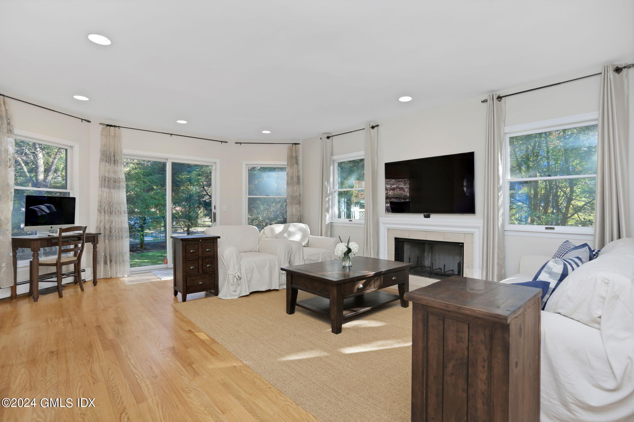 44 Hendrie Avenue Riverside, CT 06878 - Photo 4 of 40 a living room with furniture a fireplace and a flat screen tv
