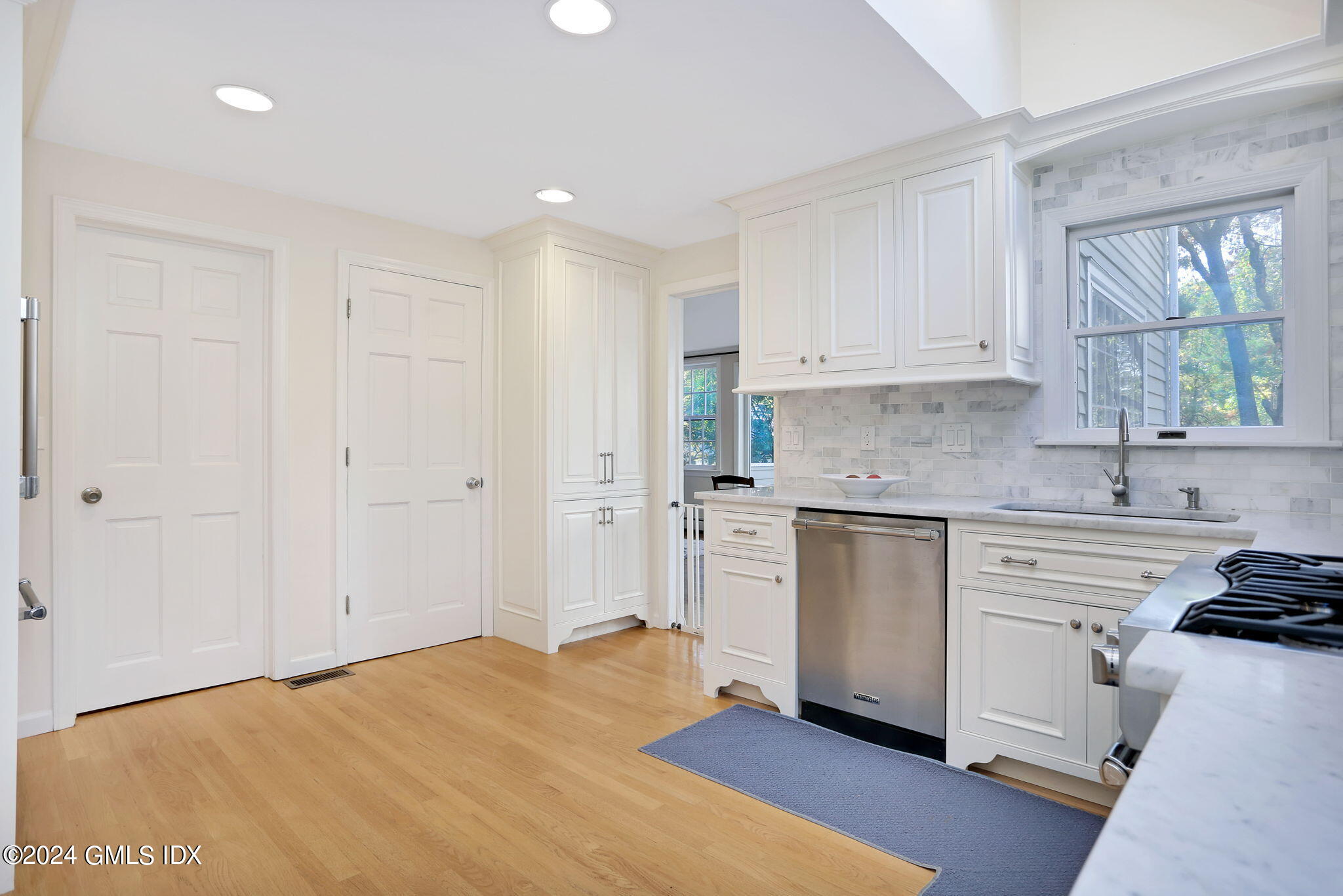 44 Hendrie Avenue Riverside, CT 06878 - Photo 8 of 40 a kitchen with granite countertop white cabinets and white appliances