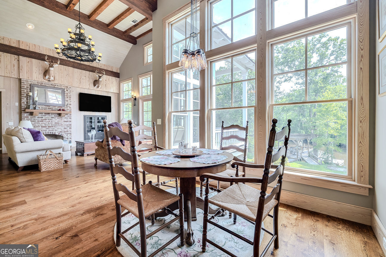 165 Shearouse Landing Brooklet, GA 30415 - Photo 12 of 78 a view of a dining room with furniture and wooden floor