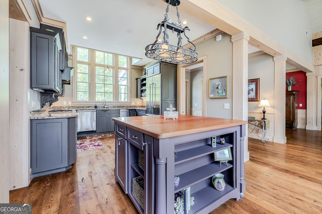 165 Shearouse Landing Brooklet, GA 30415 - Photo 13 of 78 a kitchen with a stove kitchen island wooden floor and refrigerator
