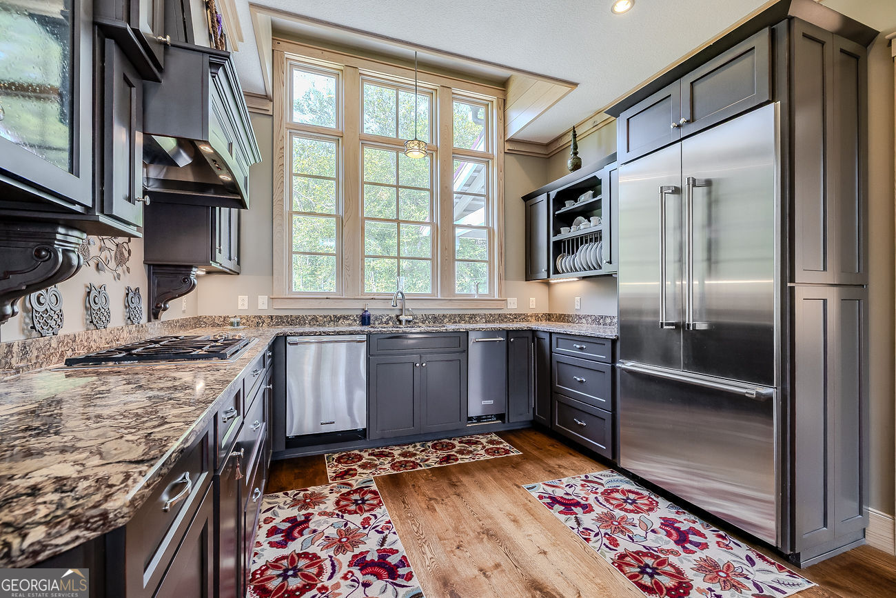 165 Shearouse Landing Brooklet, GA 30415 - Photo 15 of 78 a kitchen with stainless steel appliances granite countertop a stove a sink and a refrigerator