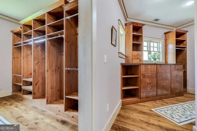 a spacious bathroom with a granite countertop sink a mirror and a shower