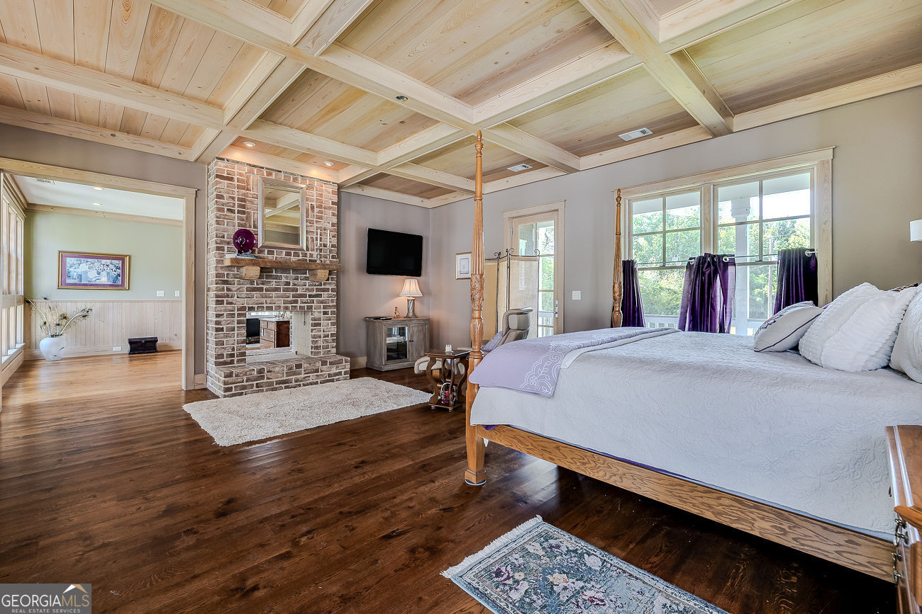 165 Shearouse Landing Brooklet, GA 30415 - Photo 26 of 78 a bed room with a bed window and a flat screen tv