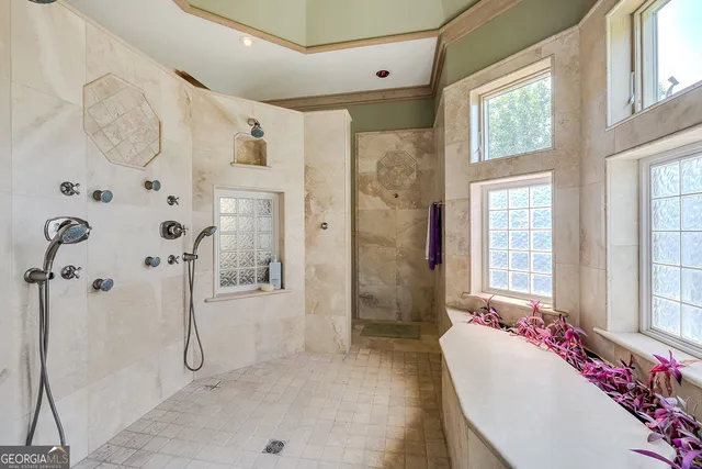 a large kitchen with stainless steel appliances kitchen island granite countertop a refrigerator and a sink