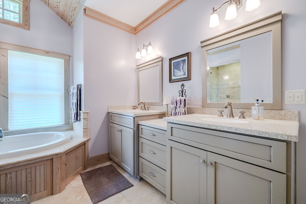 165 Shearouse Landing Brooklet, GA 30415 - Photo 44 of 78 a spacious bathroom with a granite countertop sink a mirror and a bathtub