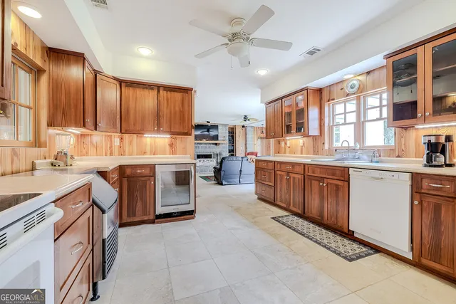 an aerial view of residential houses with outdoor space and trees